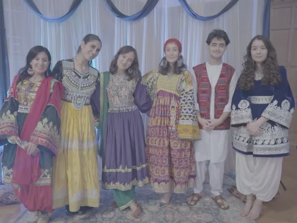 Students in traditional Afghan attire gathered at an OFAS event.